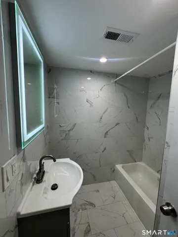 a bathroom with a sink and mirror