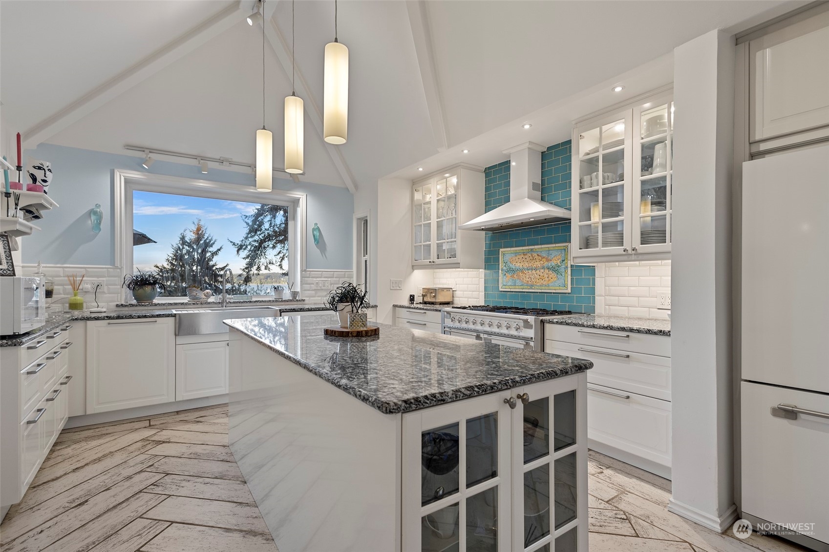 4903 Saratoga Road Langley, WA 98260 - Photo 14 of 40 a kitchen with stainless steel appliances granite countertop a sink stove and cabinets