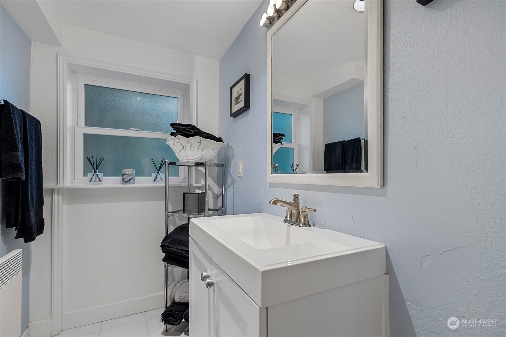 4903 Saratoga Road Langley, WA 98260 - Photo 23 of 40 a bathroom with a sink and a mirror