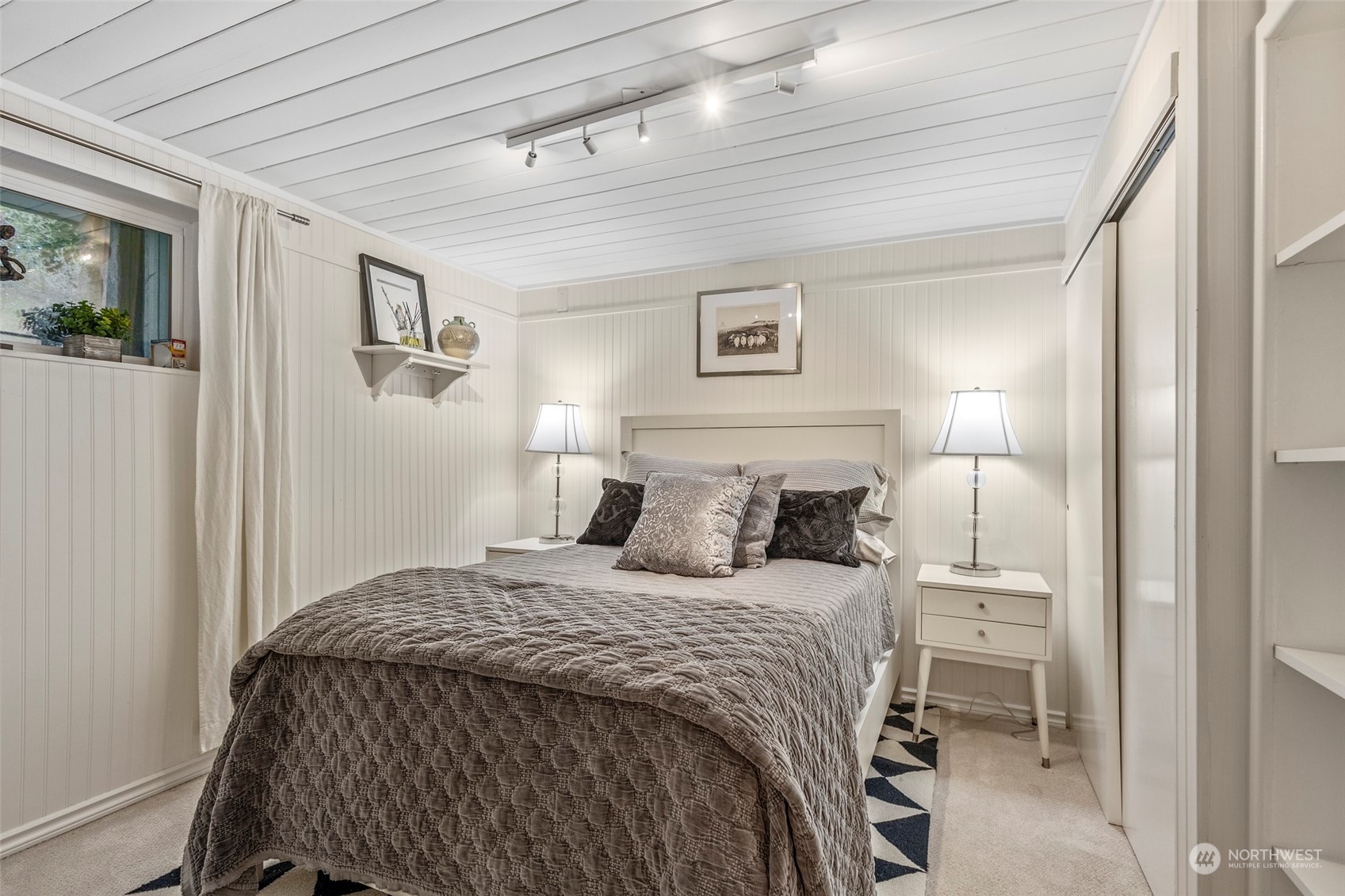 4903 Saratoga Road Langley, WA 98260 - Photo 26 of 40 a bedroom with a bed and a table