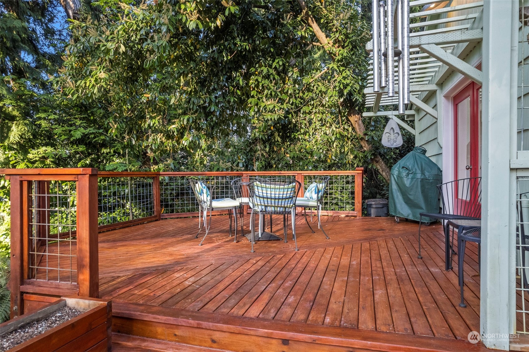 4903 Saratoga Road Langley, WA 98260 - Photo 30 of 40 a view of a house with backyard porch and sitting area