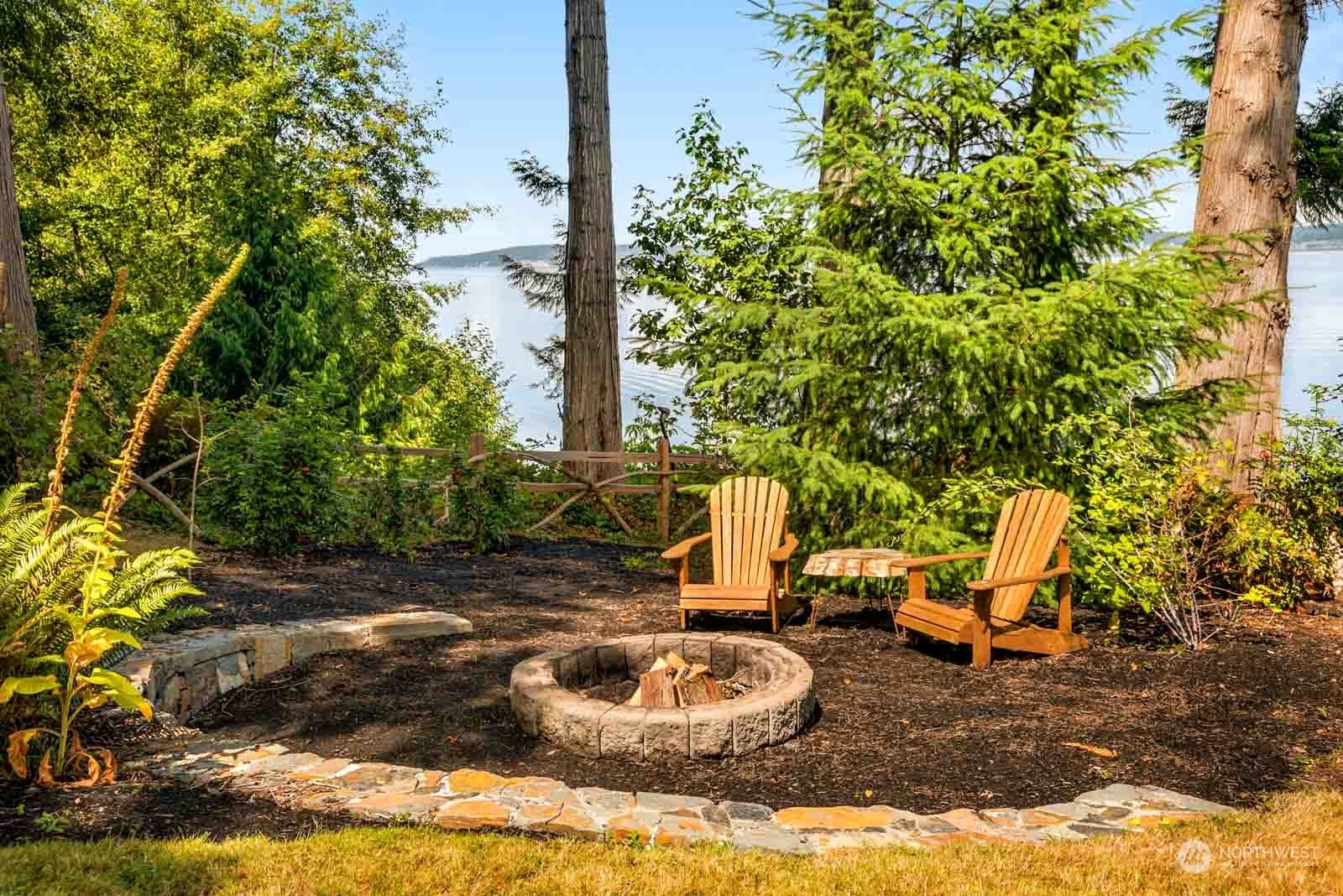 4903 Saratoga Road Langley, WA 98260 - Photo 36 of 40 a backyard of a house with fountain table and chairs