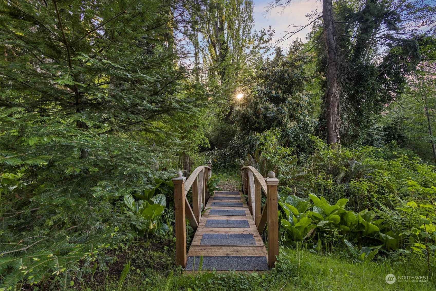 4903 Saratoga Road Langley, WA 98260 - Photo 37 of 40 a view of a yard with plants and a bench