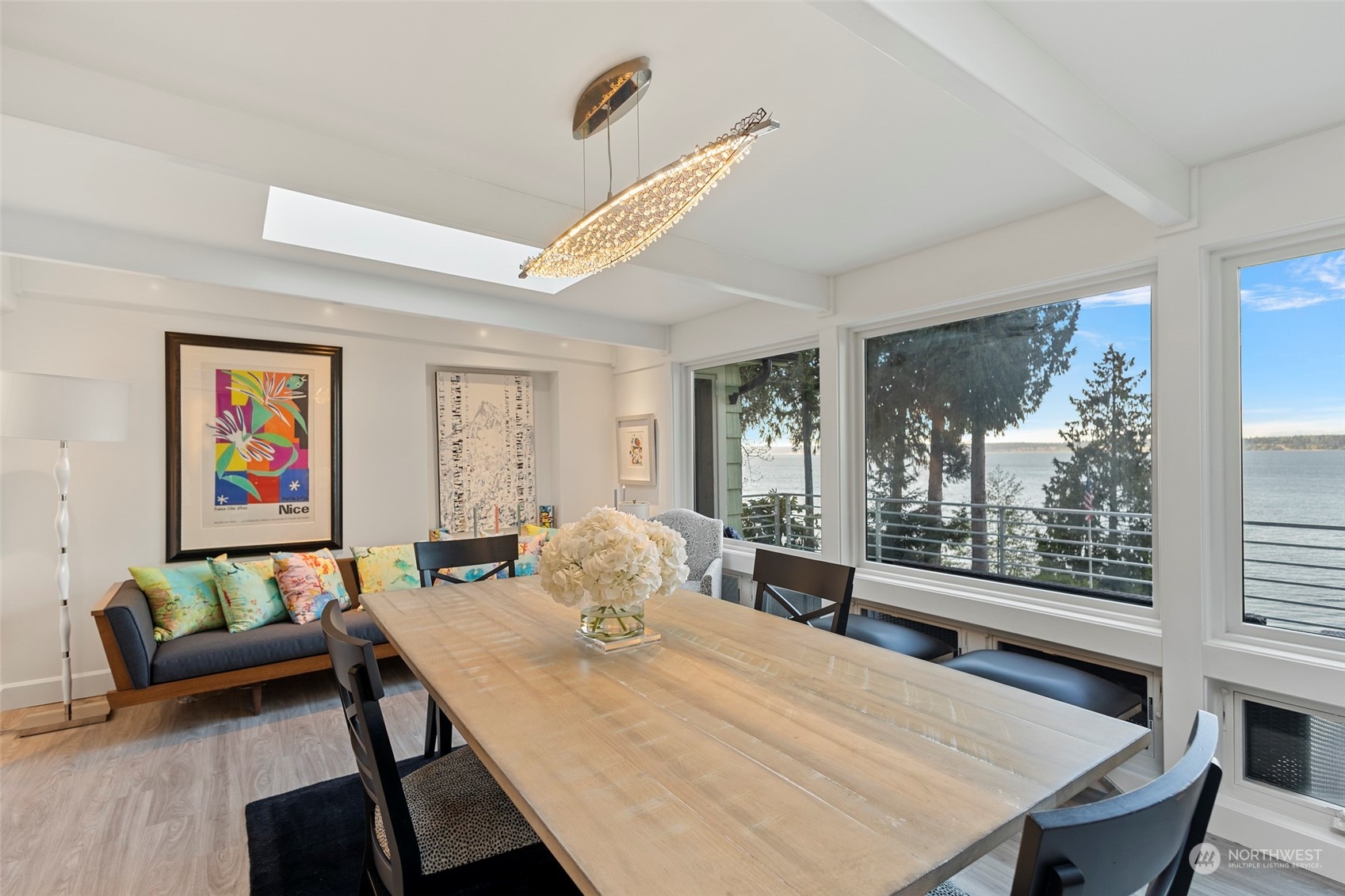 4903 Saratoga Road Langley, WA 98260 - Photo 8 of 40 a view of a dining room with furniture large windows and wooden floor