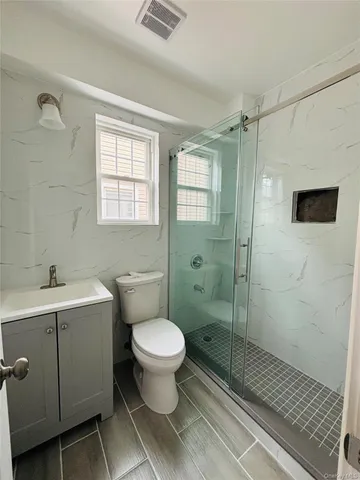 a bathroom with a toilet sink and shower