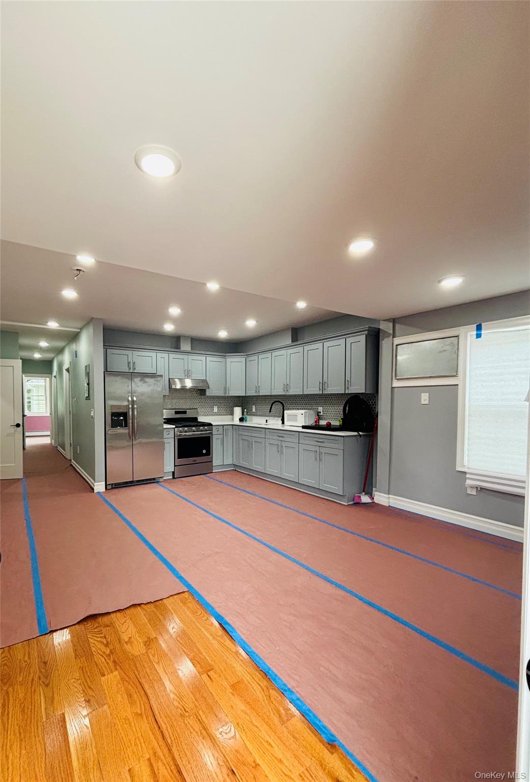 104-39 210th Street Queens, NY 11429 - Photo 3 of 18 a large room with stainless steel appliances lots of counter space and cabinets