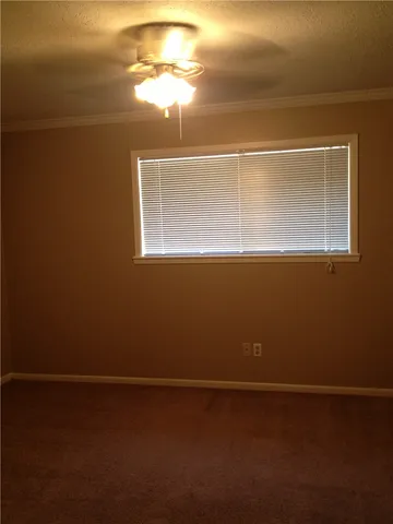 a view of a livingroom with an empty space and a window