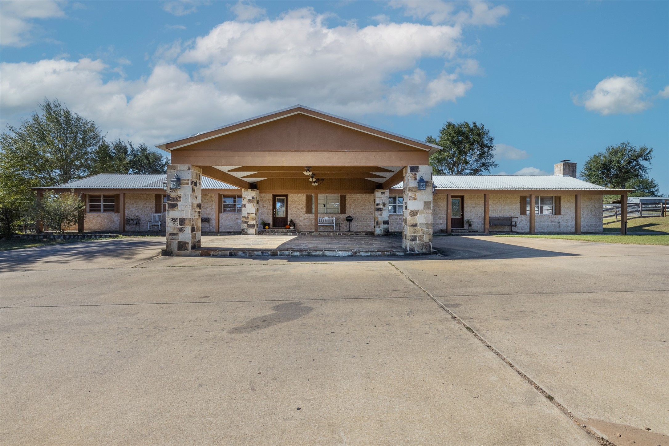 a patio with a table and chairs under an umbrella