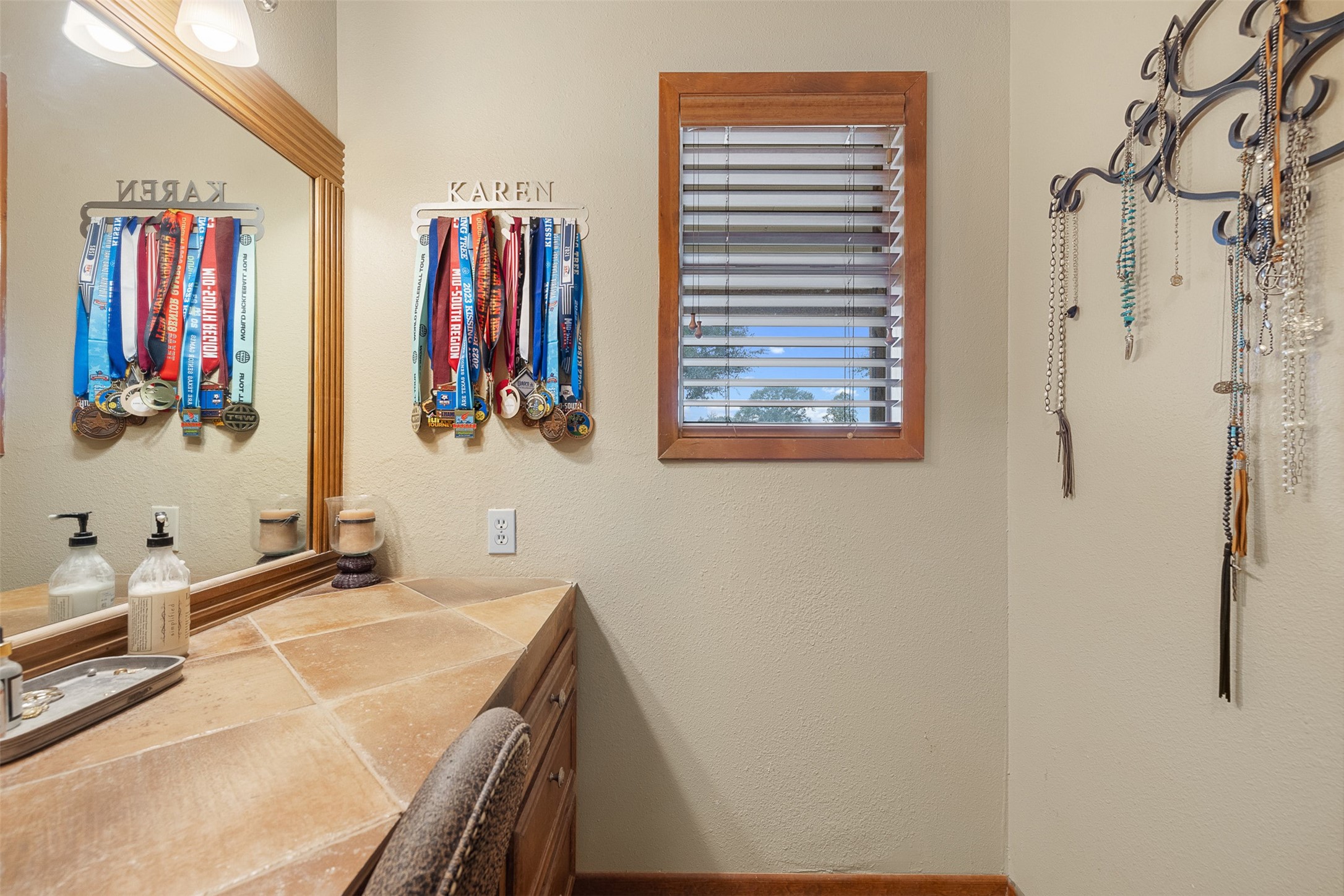1611 Koy Road Bellville, TX 77418 - Photo 21 of 44 a bathroom with a granite countertop tub a sink and a large mirror