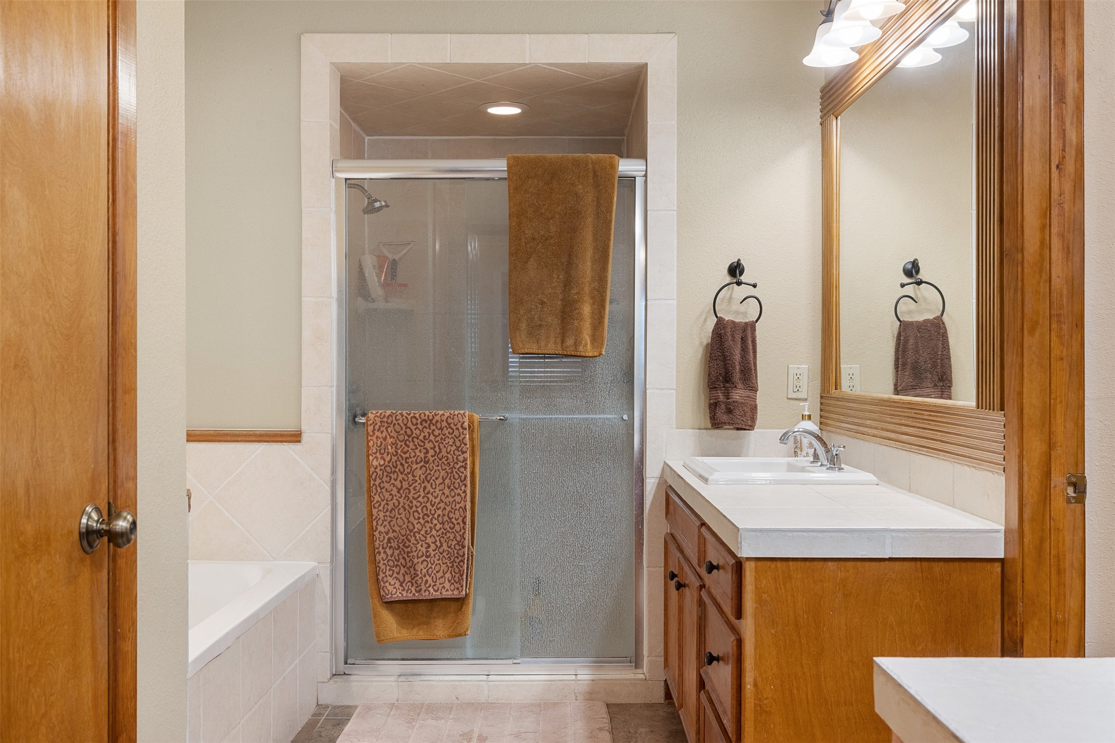 1611 Koy Road Bellville, TX 77418 - Photo 23 of 44 a bathroom with a tub sink and mirror