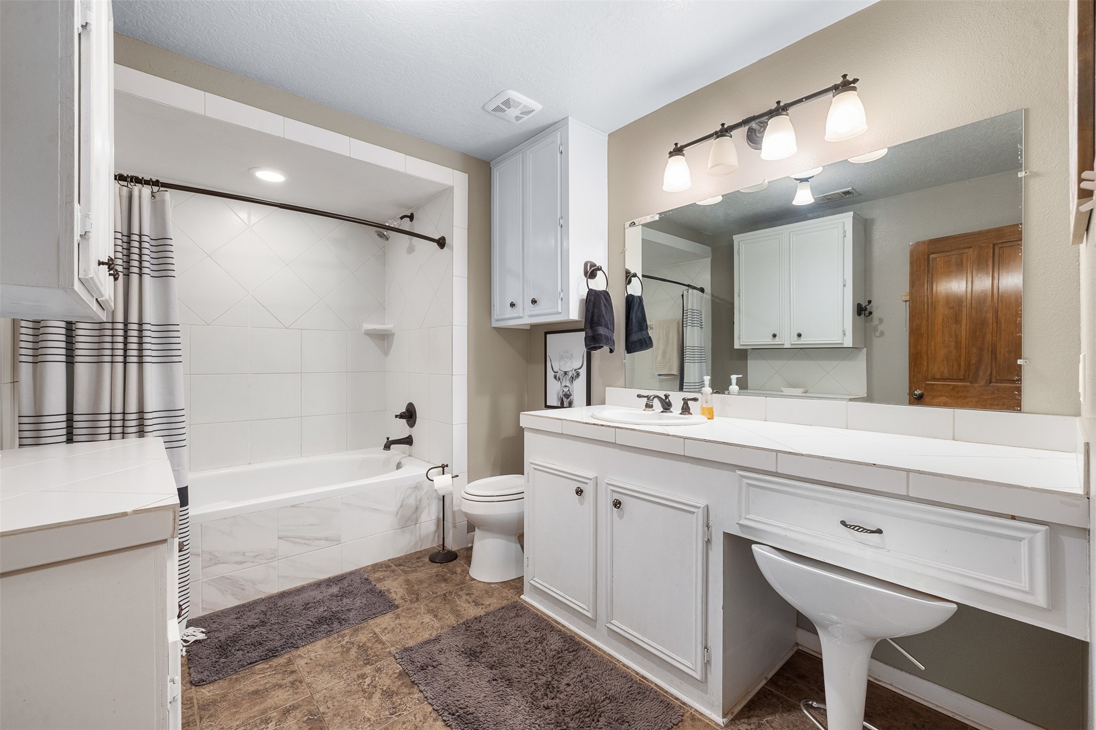 1611 Koy Road Bellville, TX 77418 - Photo 25 of 44 a bathroom with a bathtub shower sink vanity and toilet