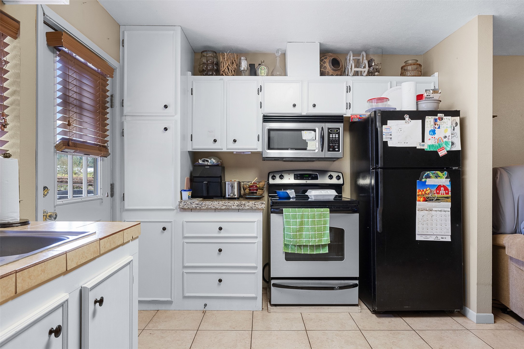 1611 Koy Road Bellville, TX 77418 - Photo 36 of 44 a kitchen with stainless steel appliances a refrigerator and a stove top oven
