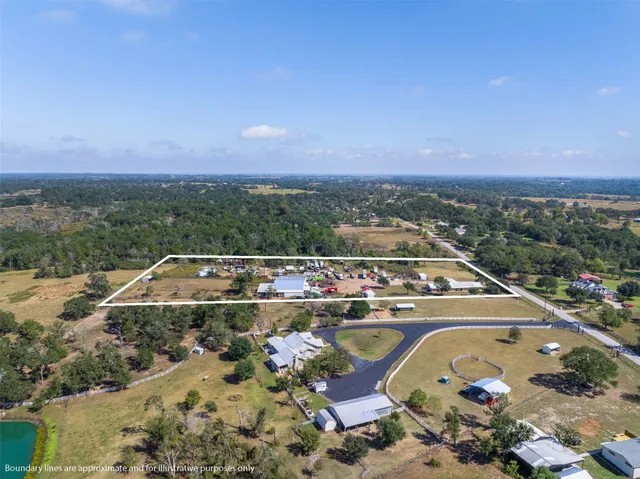 an aerial view of a house with a swimming pool