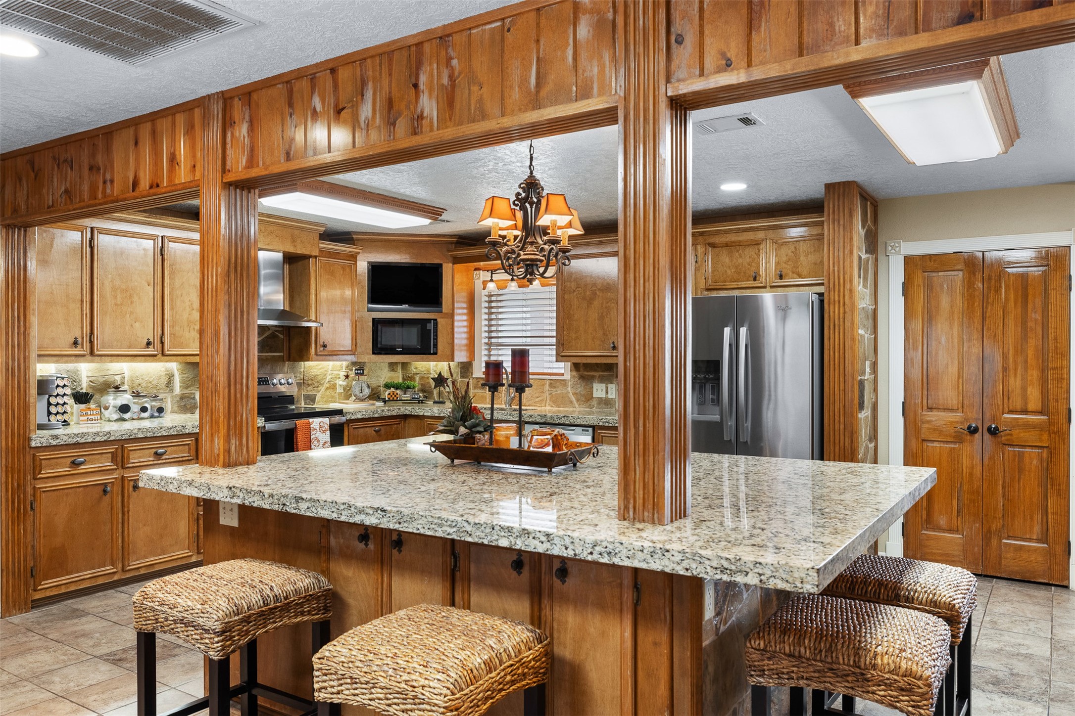 1611 Koy Road Bellville, TX 77418 - Photo 9 of 44 a kitchen with granite countertop a table chairs in it and wooden floor
