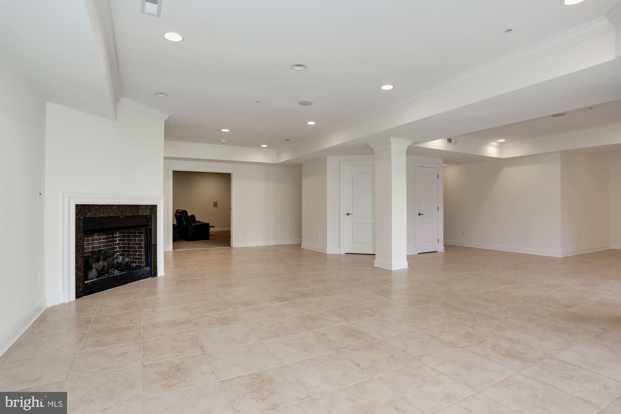 8705 Falls Road Potomac, MD 20854 - Photo 51 of 67 Lower level recreation room with gas fireplace