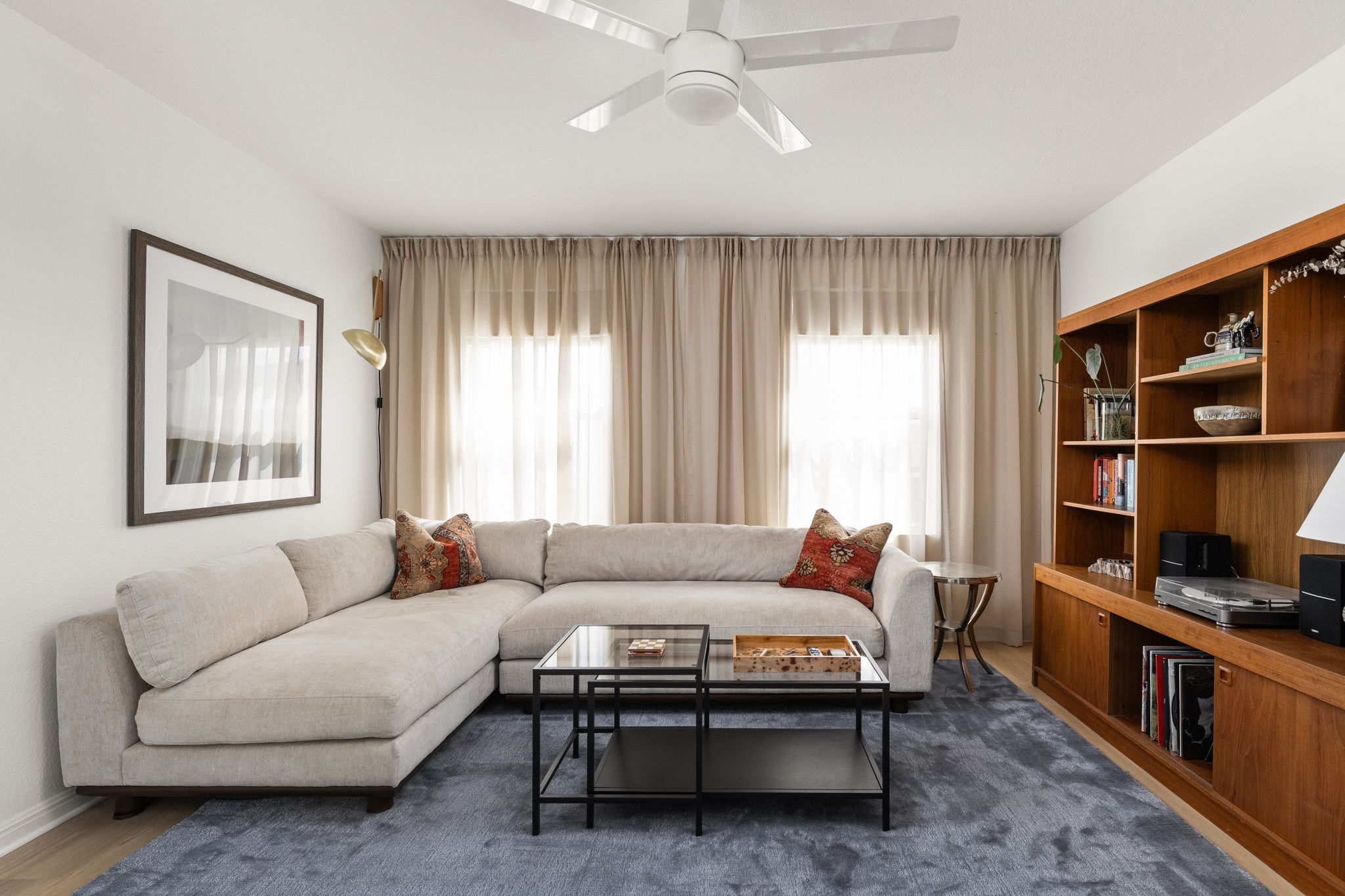 a living room with furniture and a book shelf