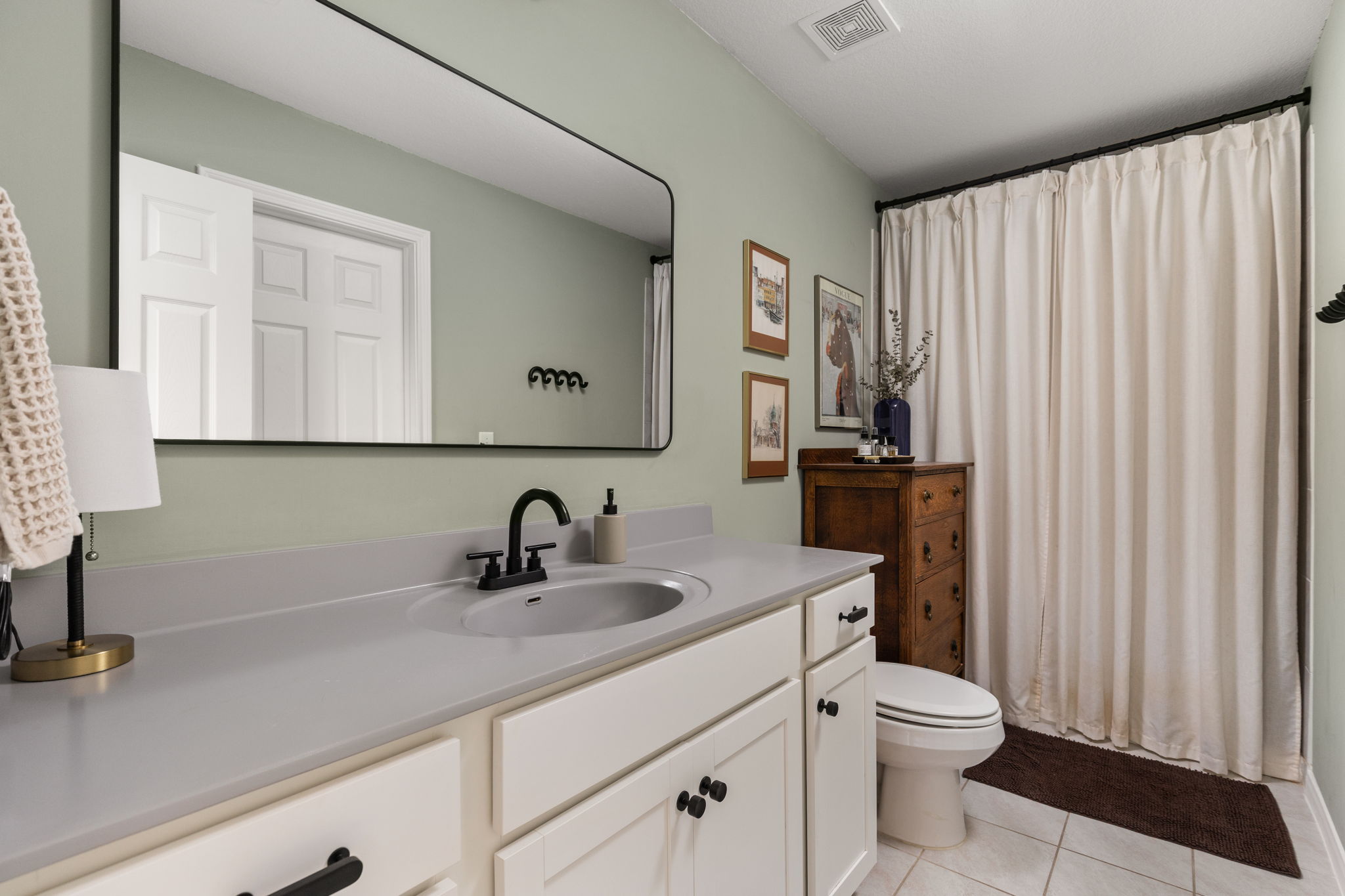6702 Routenburn Street Austin, TX 78754 - Photo 13 of 24 a bathroom with a sink a toilet and a mirror