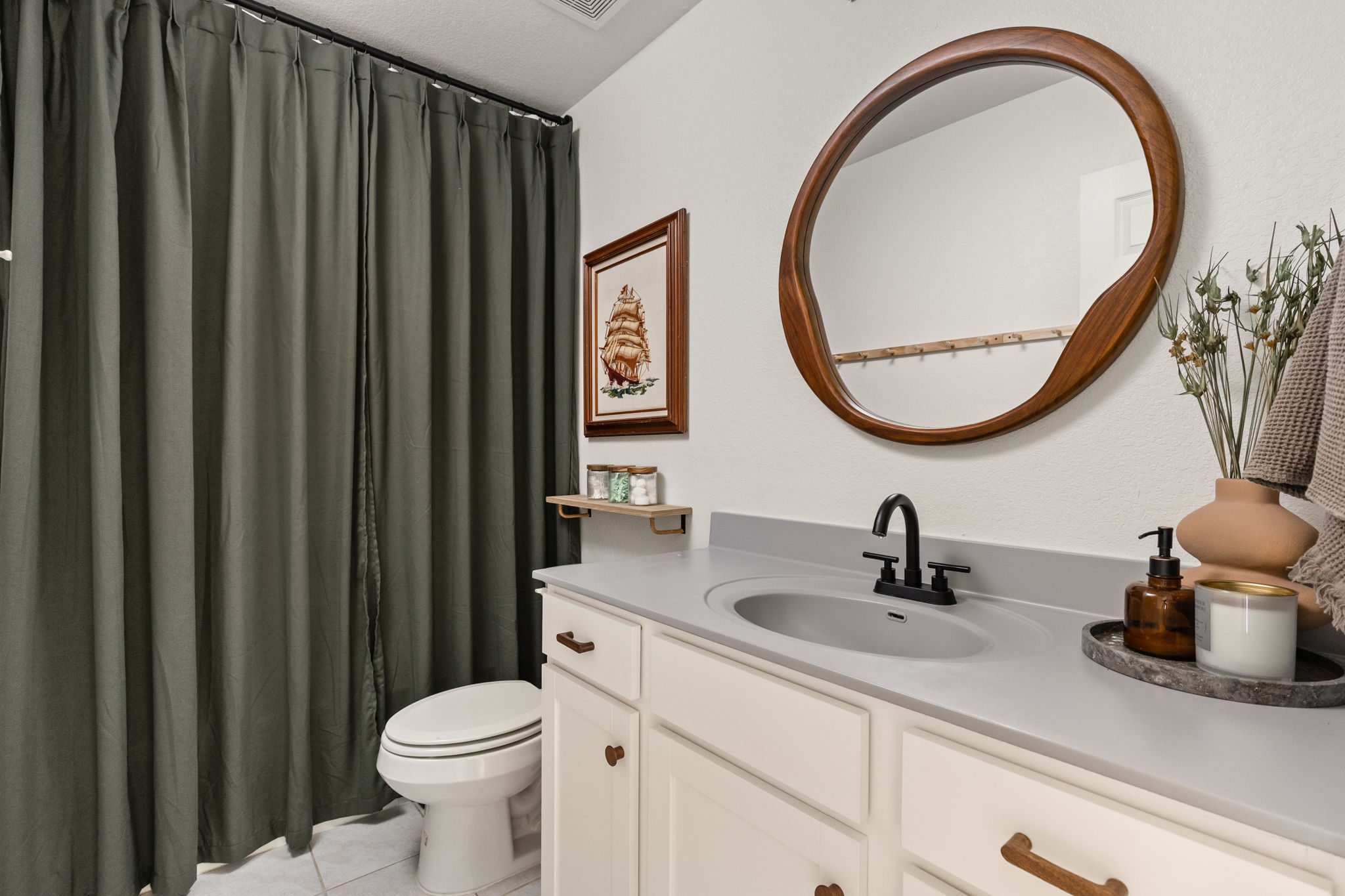 6702 Routenburn Street Austin, TX 78754 - Photo 16 of 24 a bathroom with a sink a toilet and a mirror