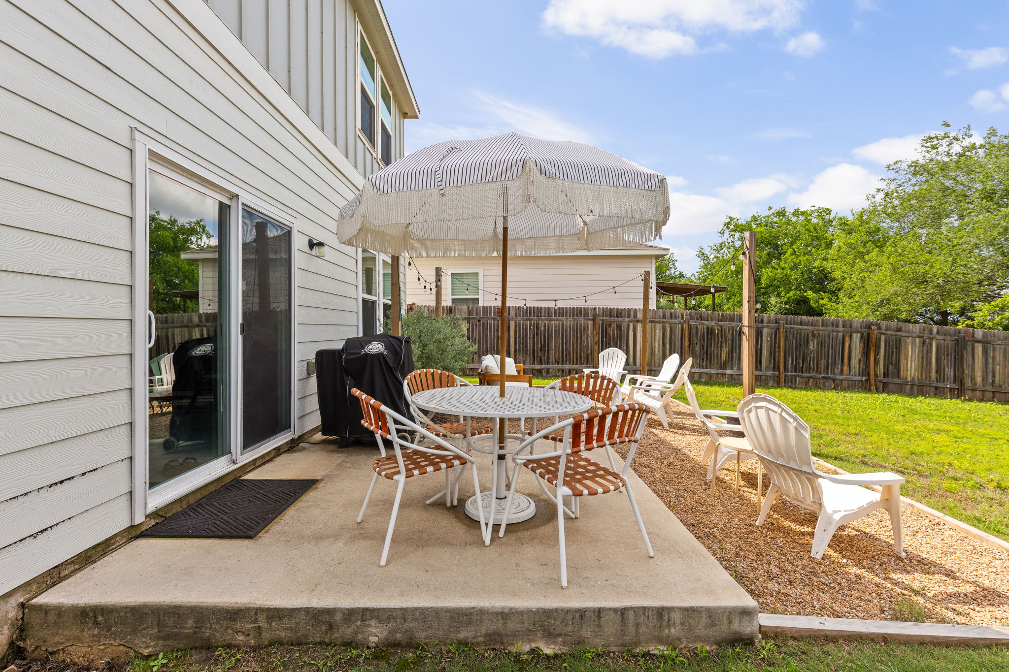 6702 Routenburn Street Austin, TX 78754 - Photo 18 of 24 a view of a patio with a dining table and chairs with wooden fence