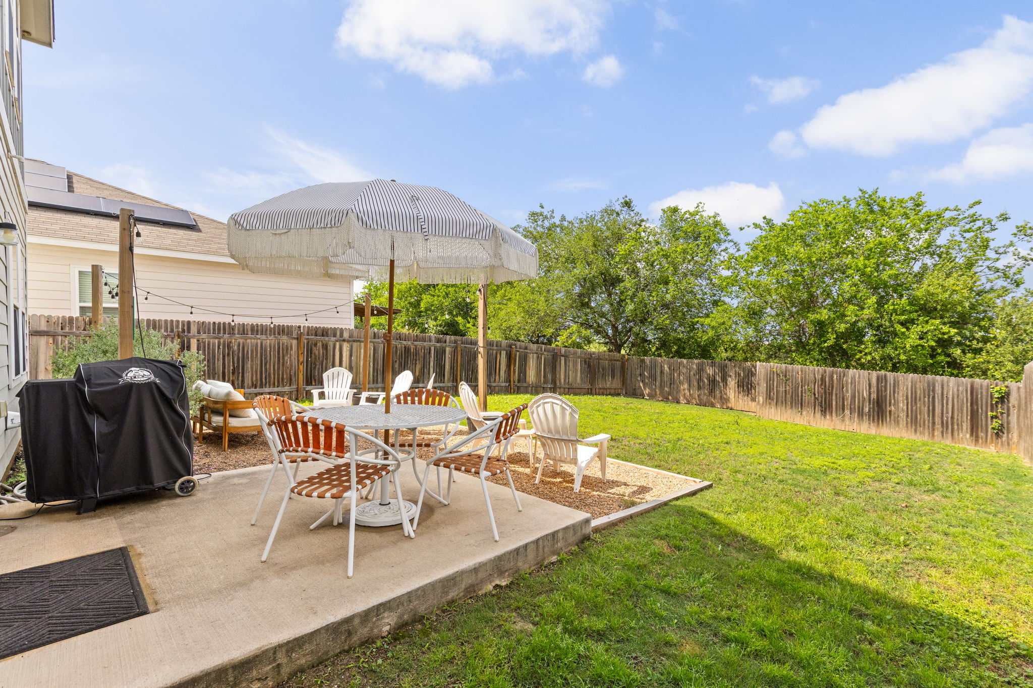 6702 Routenburn Street Austin, TX 78754 - Photo 2 of 24 a view of a chairs and table in patio with a yard