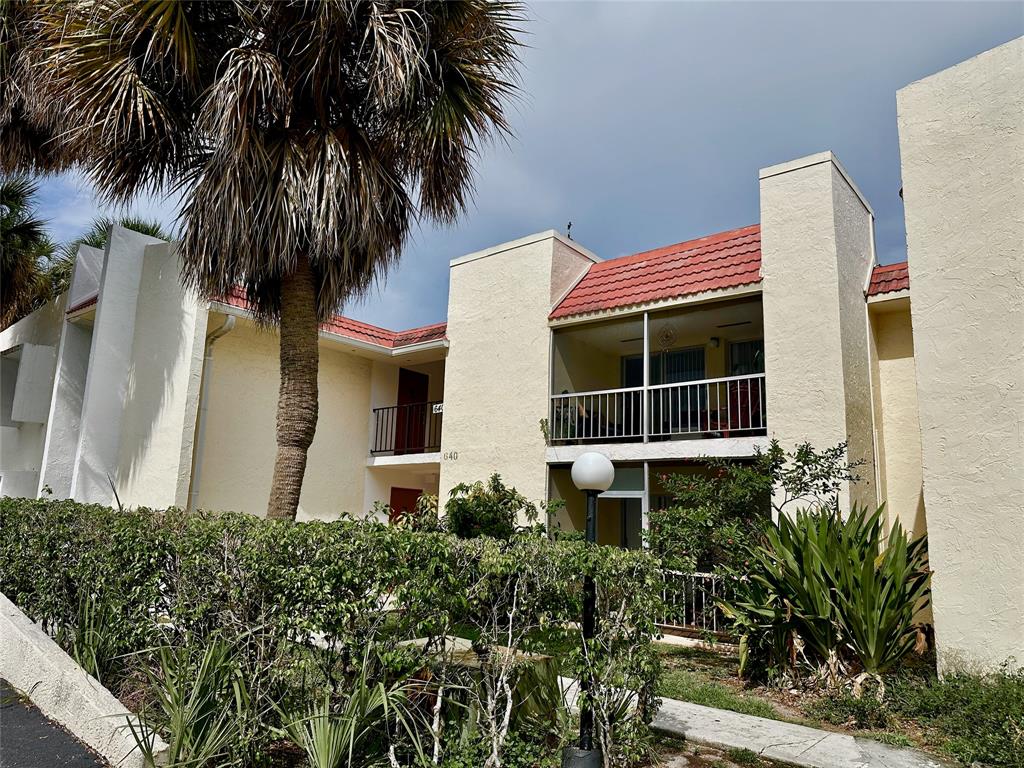 640 Northwest 13th Street, Unit 26 Boca Raton, FL 33486 - Photo 1 of 11 a front view of a house with a garden