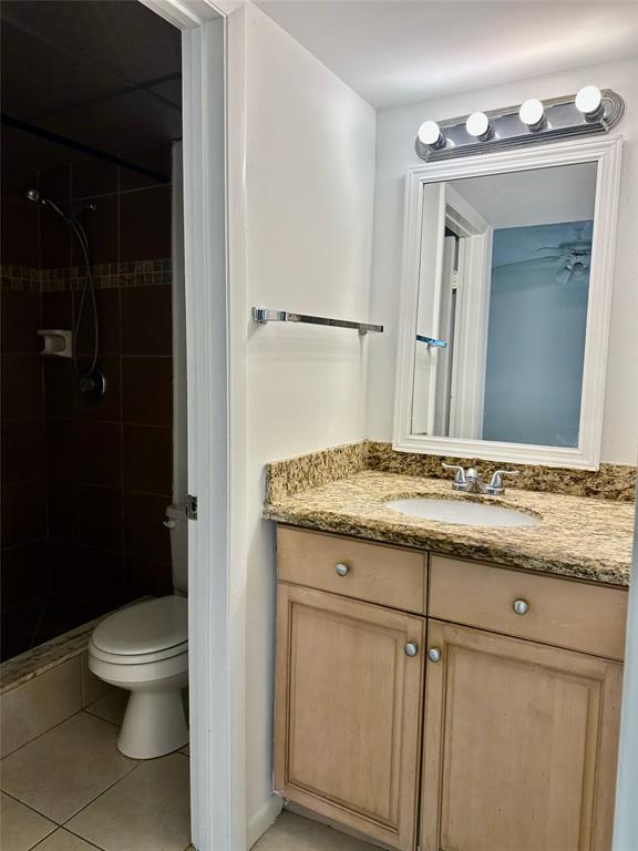 640 Northwest 13th Street, Unit 26 Boca Raton, FL 33486 - Photo 8 of 11 a bathroom with a granite countertop sink a toilet and a shower