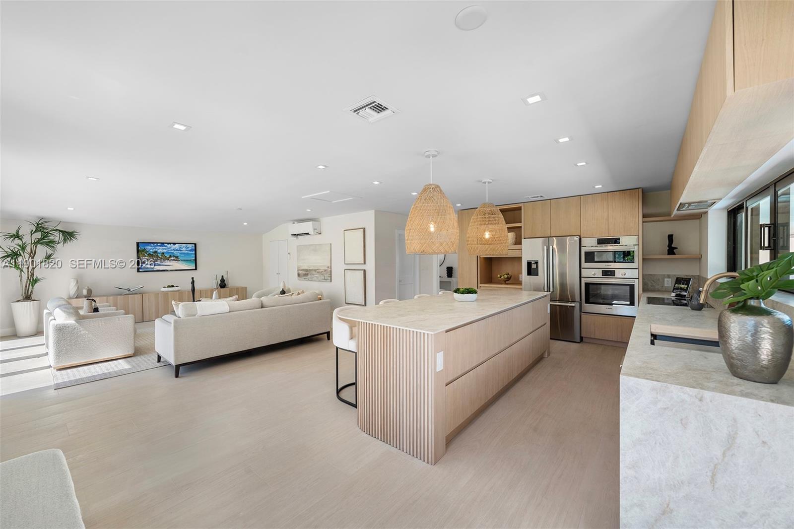 10945 Southwest 75th Court Pinecrest, FL 33156 - Photo 21 of 81 he stunning new kitchen, with a unique island bar design, flows seamlessly into the spacious playroom for modern family living