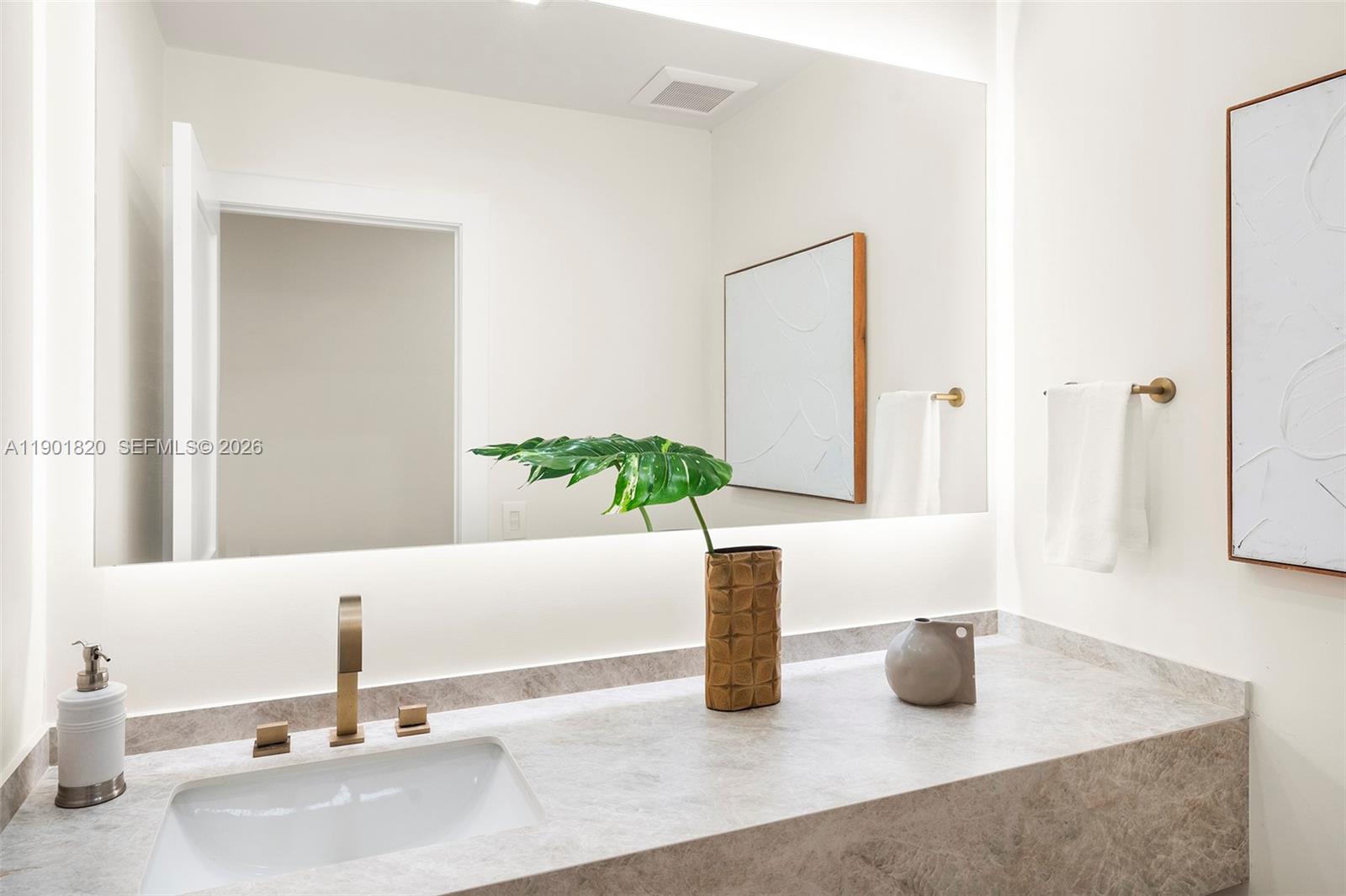 10945 Southwest 75th Court Pinecrest, FL 33156 - Photo 29 of 81 a bathroom with a sink