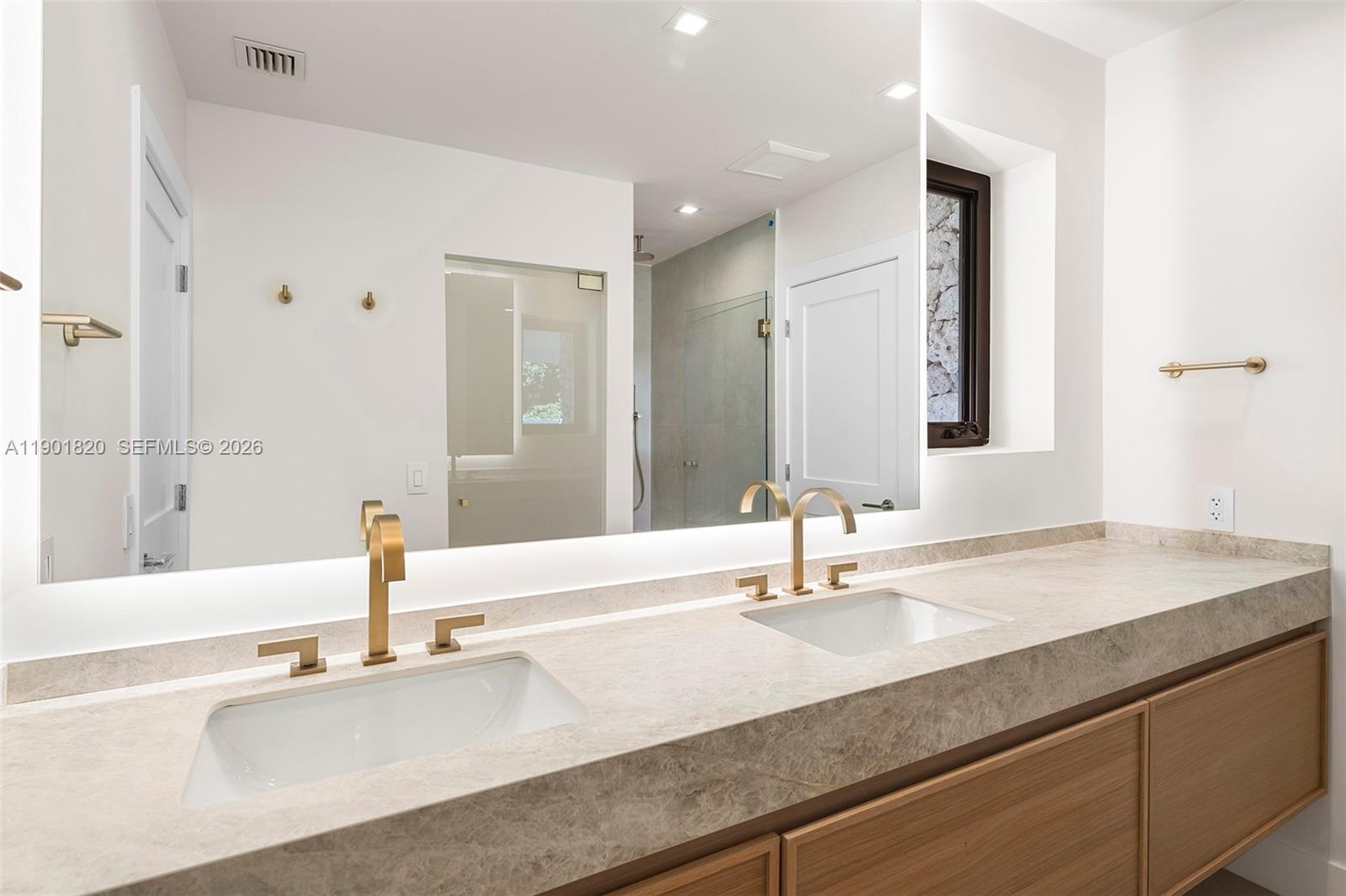 10945 Southwest 75th Court Pinecrest, FL 33156 - Photo 33 of 81 a bathroom with a sink and a mirror