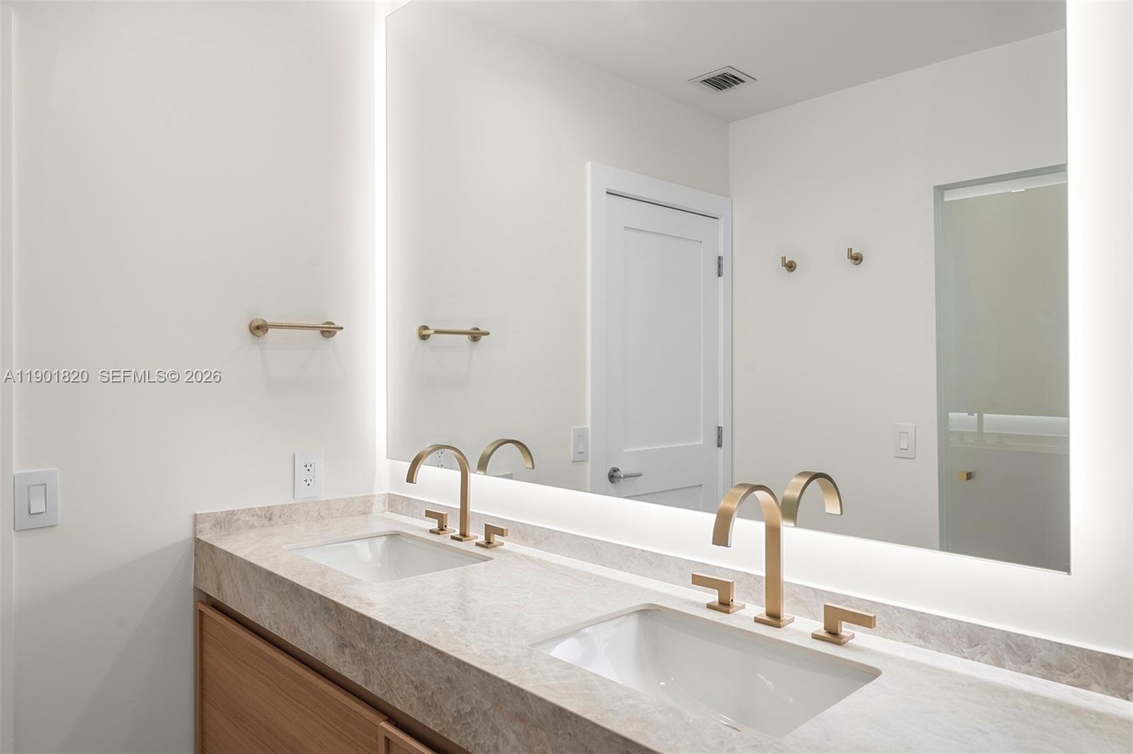 10945 Southwest 75th Court Pinecrest, FL 33156 - Photo 35 of 81 a bathroom with a sink and a mirror