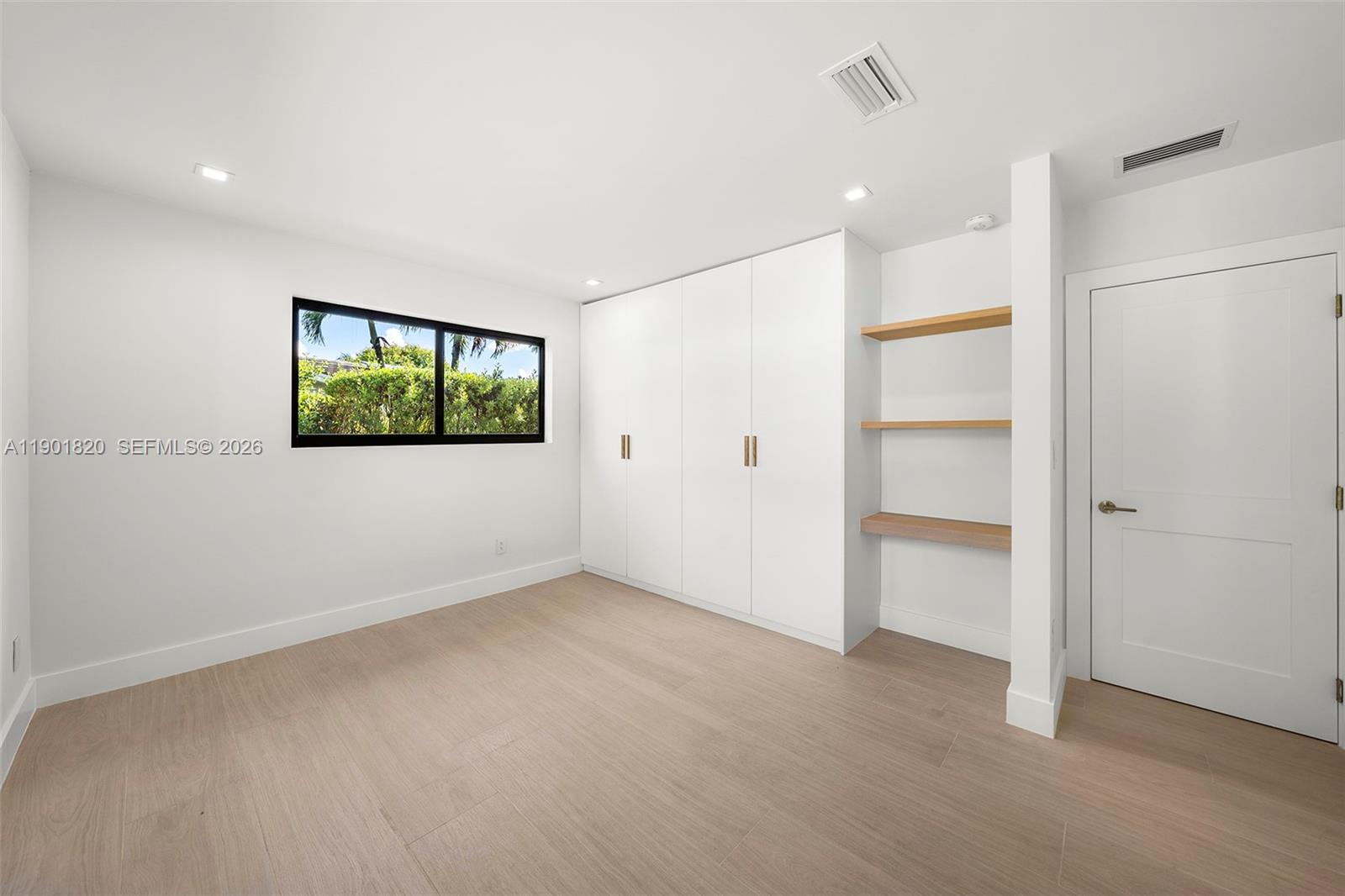 10945 Southwest 75th Court Pinecrest, FL 33156 - Photo 37 of 81 an empty room with windows