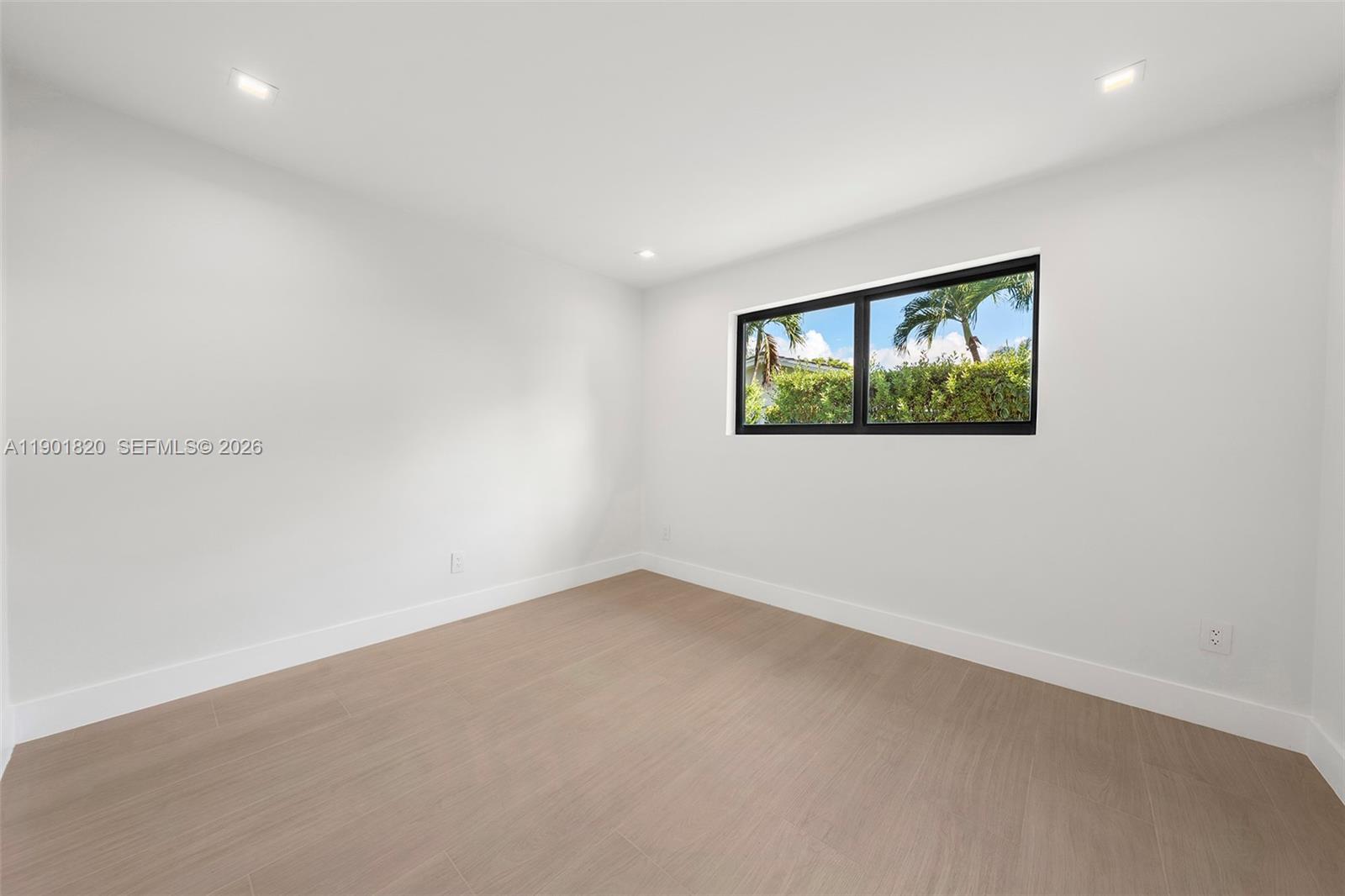 10945 Southwest 75th Court Pinecrest, FL 33156 - Photo 42 of 81 an empty room with windows