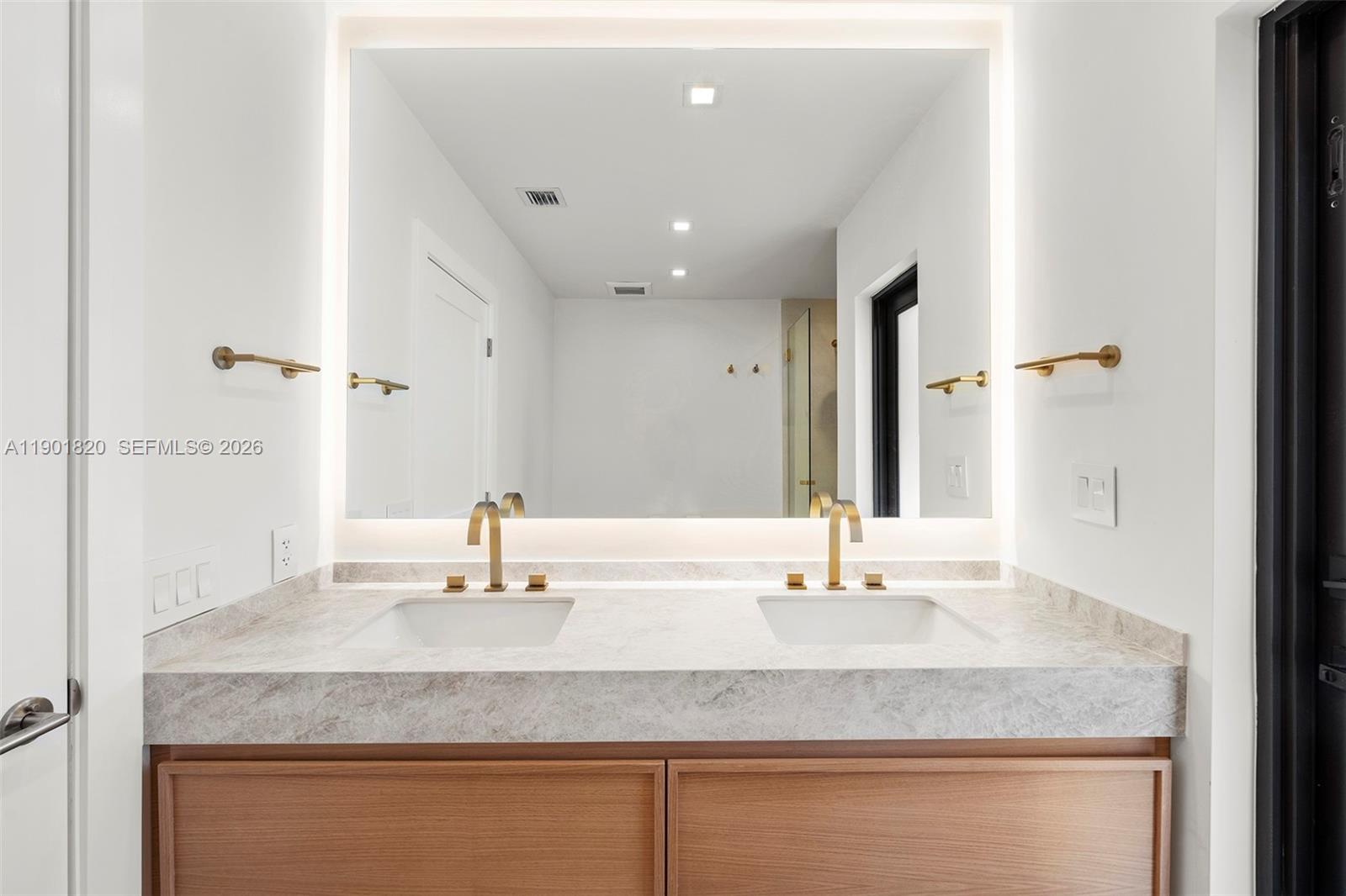 10945 Southwest 75th Court Pinecrest, FL 33156 - Photo 53 of 81 a bathroom with a granite countertop sink and a mirror