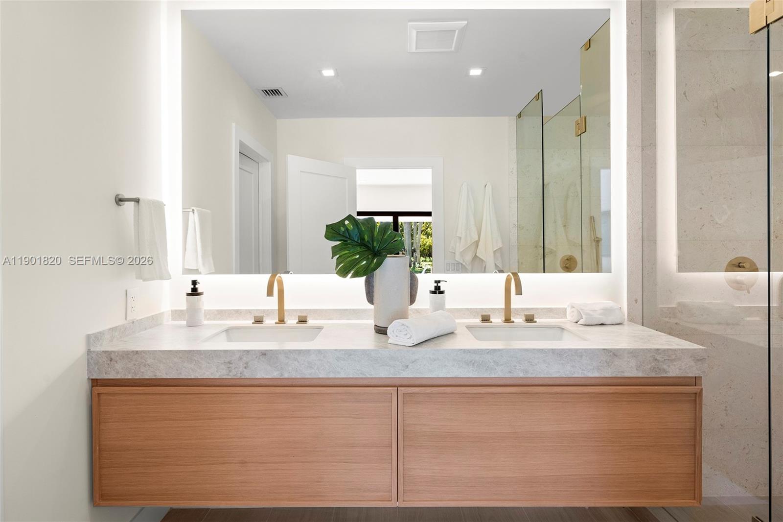 10945 Southwest 75th Court Pinecrest, FL 33156 - Photo 62 of 81 a bathroom with sinks vanity and a mirror