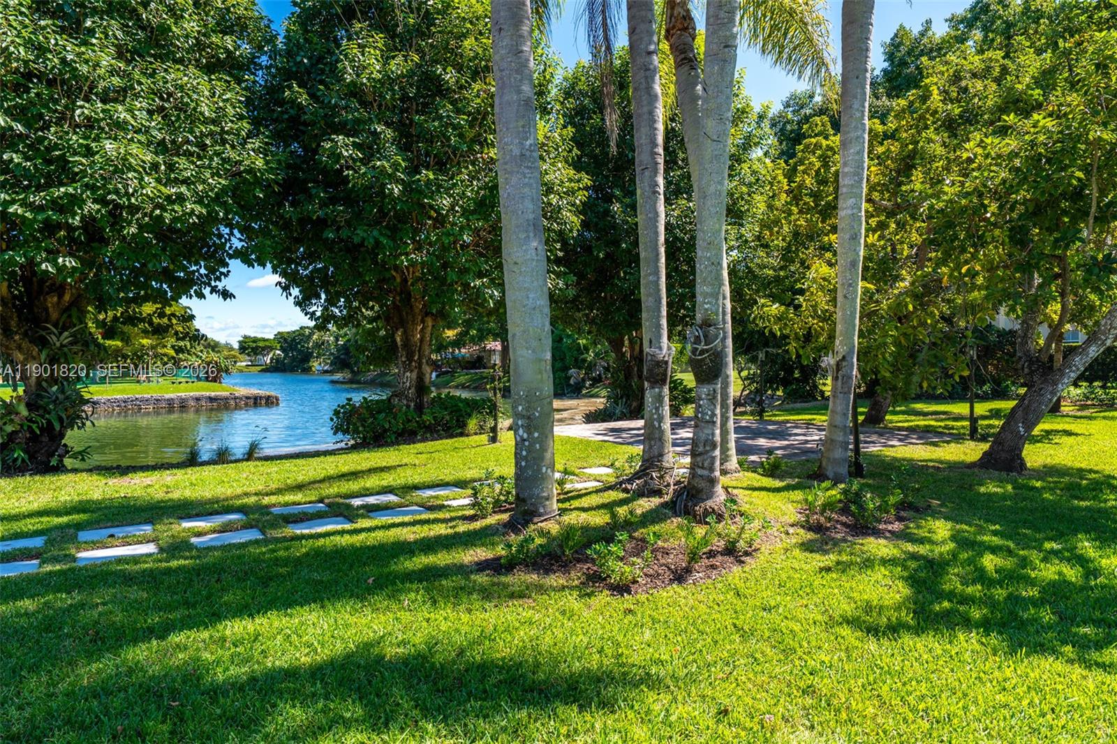 10945 Southwest 75th Court Pinecrest, FL 33156 - Photo 67 of 81 a view of a house with swimming pool and a big yard