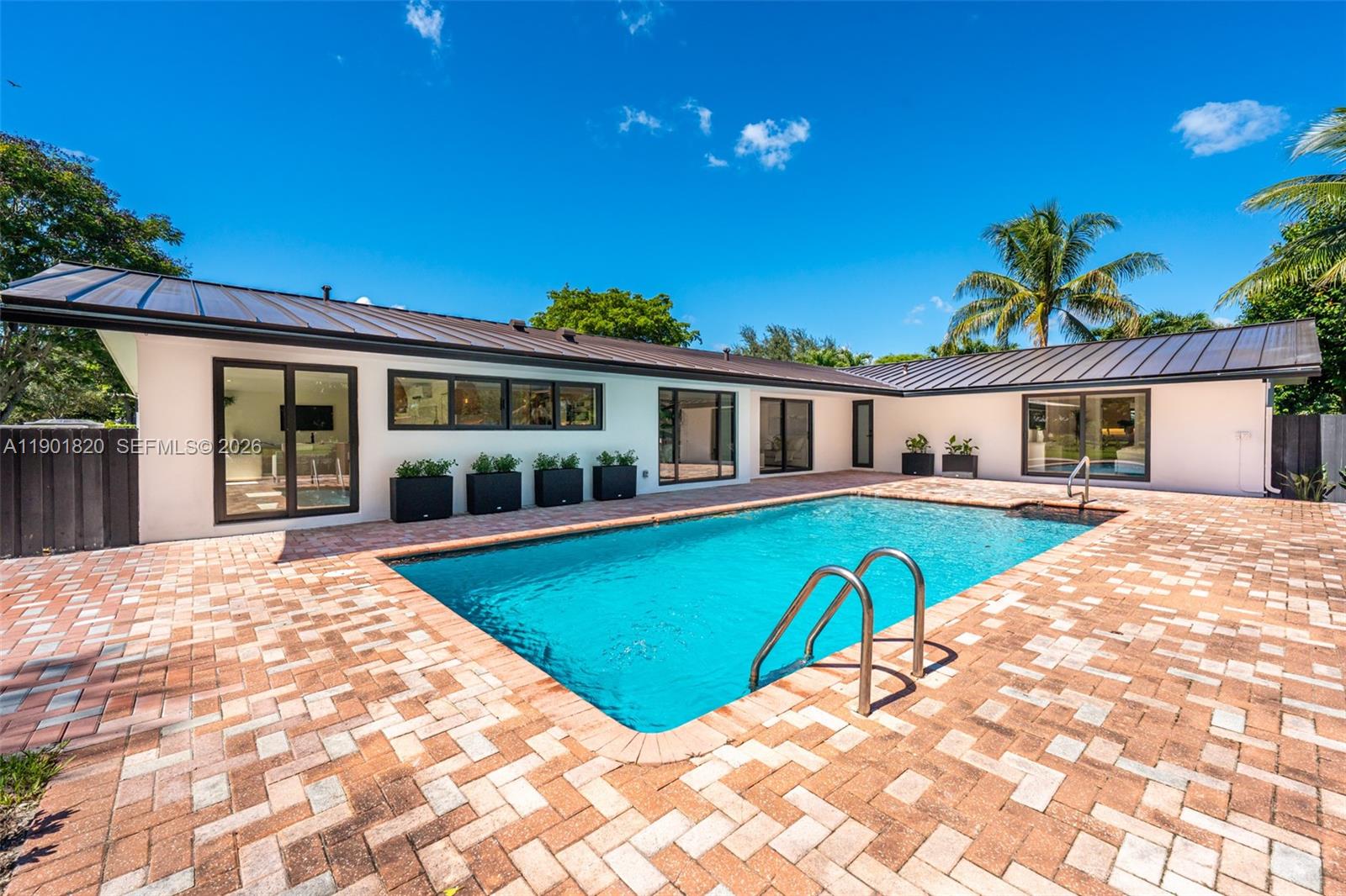 10945 Southwest 75th Court Pinecrest, FL 33156 - Photo 70 of 81 a view of a house with pool and sitting area