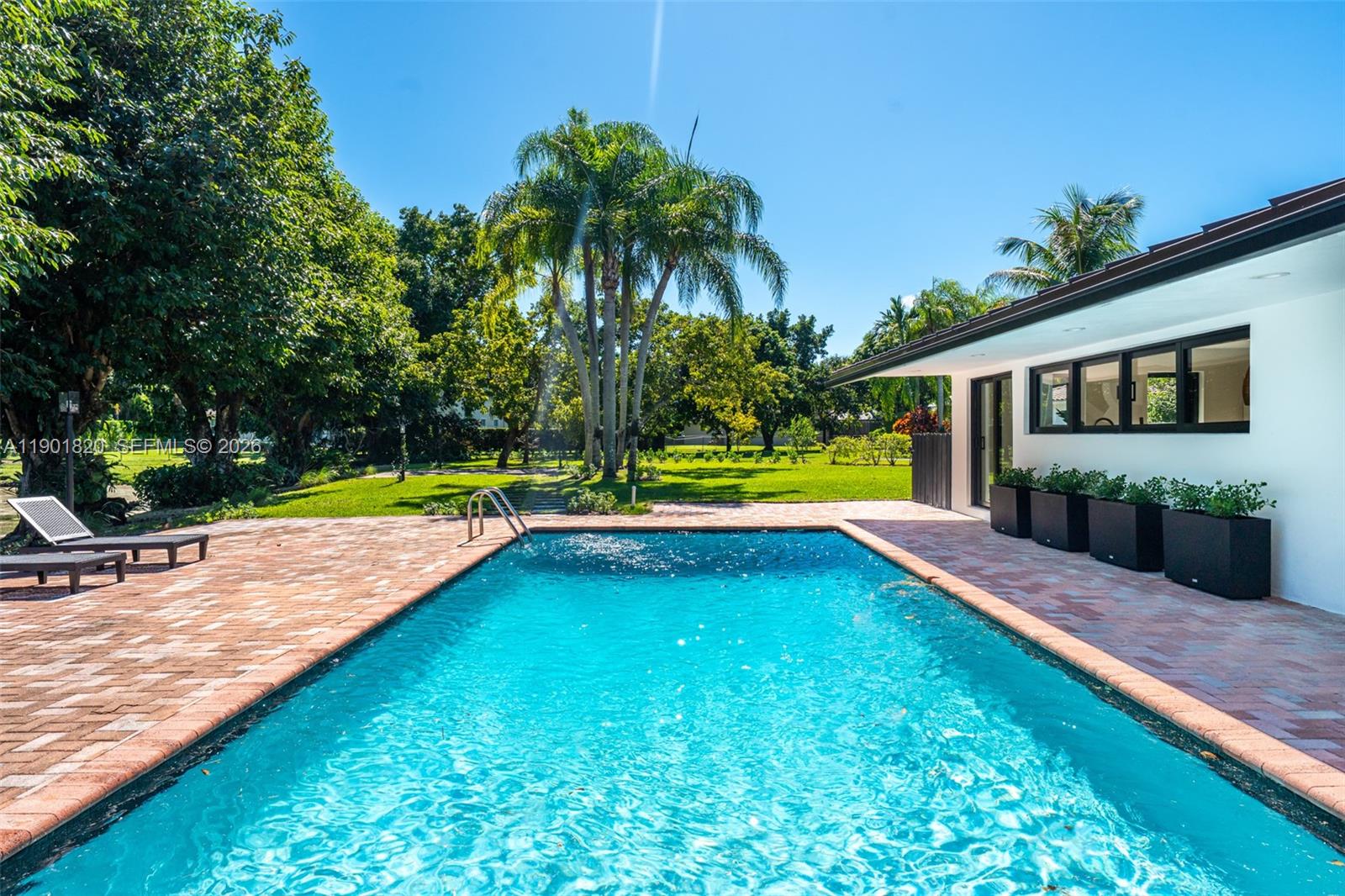 10945 Southwest 75th Court Pinecrest, FL 33156 - Photo 75 of 81 a view of a backyard with swimming pool
