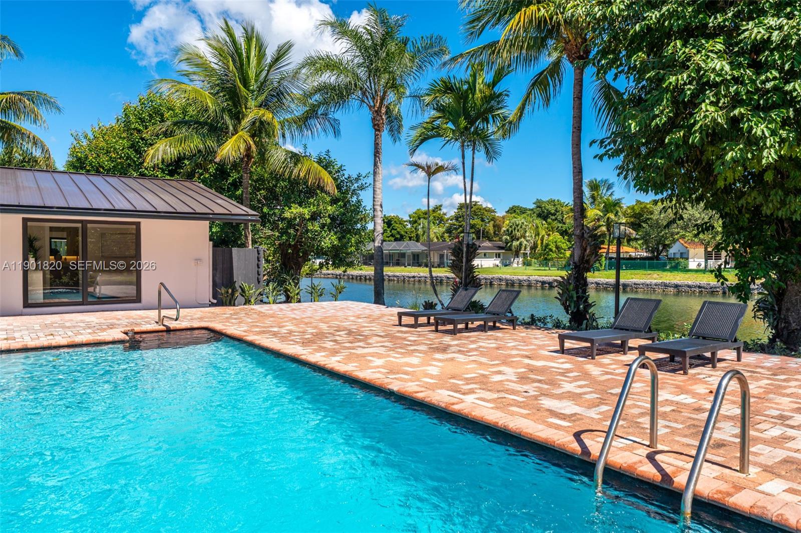 10945 Southwest 75th Court Pinecrest, FL 33156 - Photo 76 of 81 a view of an house with swimming pool and sitting area