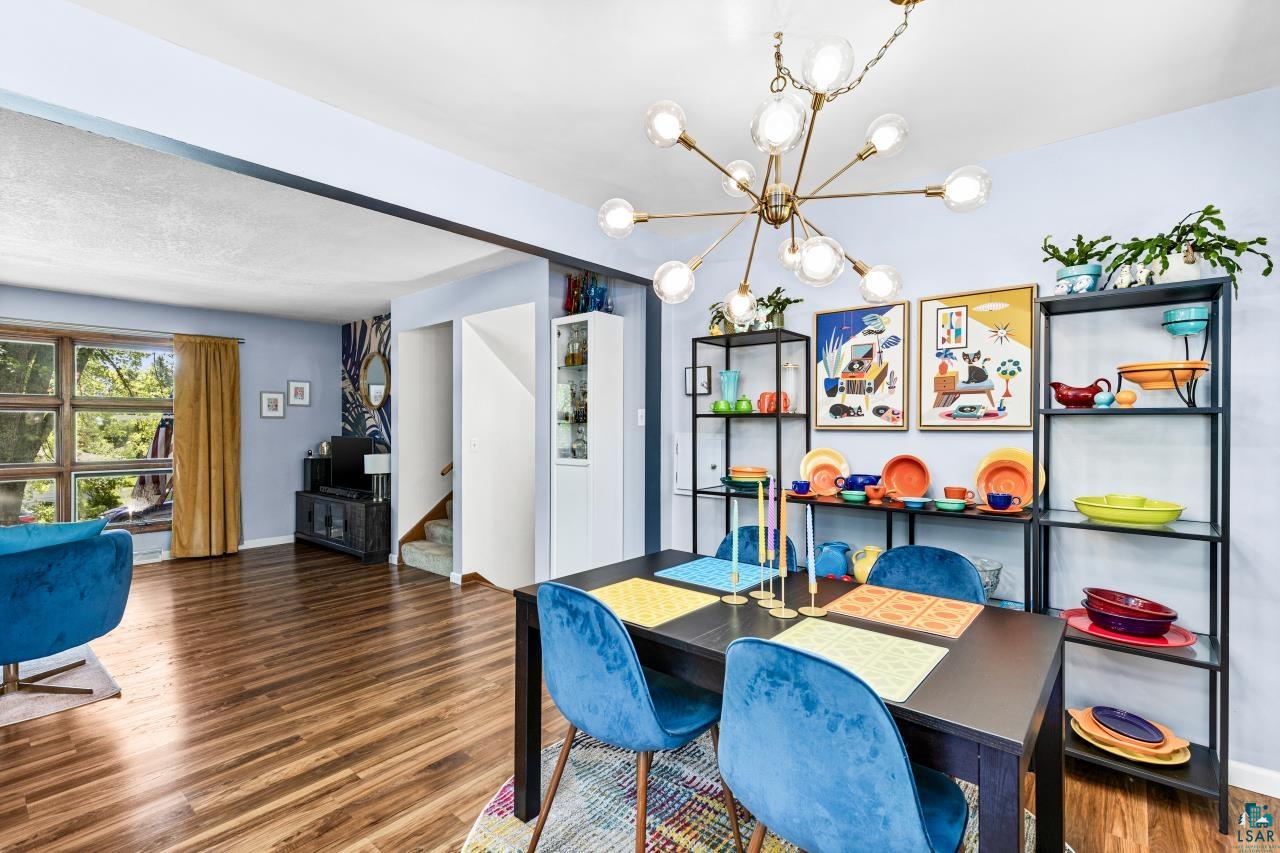 4119 Pitt Street Duluth, MN 55804 - Photo 37 of 50 Dining area featuring a modern sputnik chandelier, wood-finish flooring, and open shelving