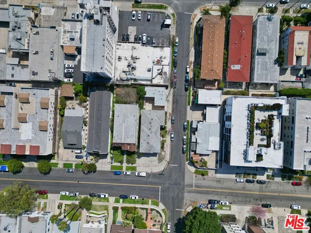 an aerial view of multi story residential apartment building with yard