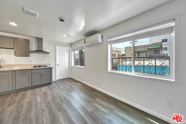 a view of a kitchen with a sink and dishwasher wooden floor