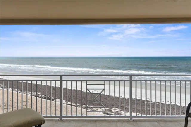 a view of a living room and a floor to ceiling window