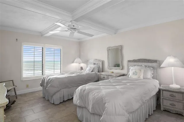 a bedroom with two beds and a chandelier