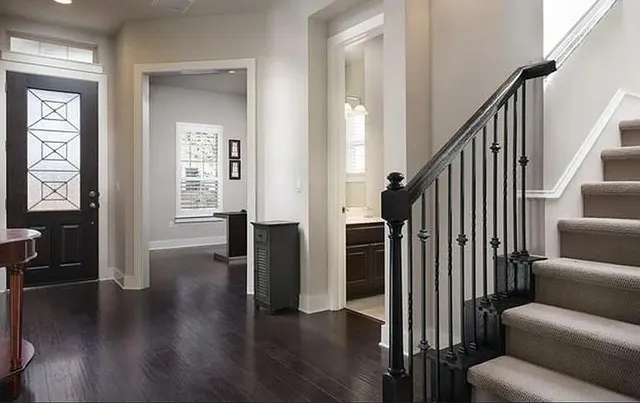 a view of kitchen and empty room with window