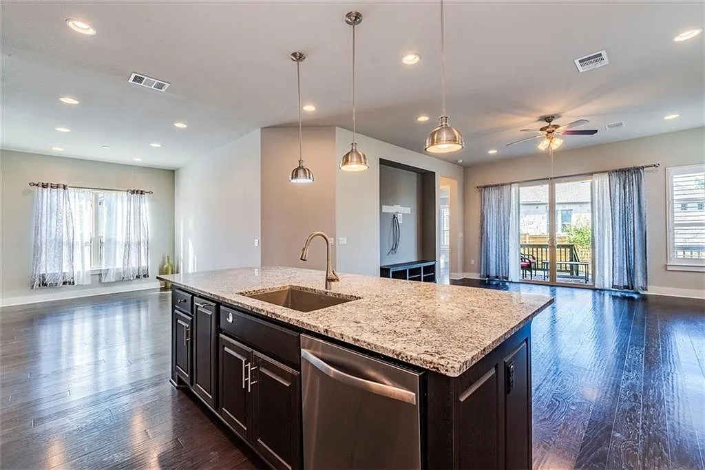 11016 Cut Plains Loop Austin, TX 78726 - Photo 2 of 12 Gourmet kitchen that flows seamlessly into the family room, complete with an oversized granite island, gas cooktop, and ample cabinetry