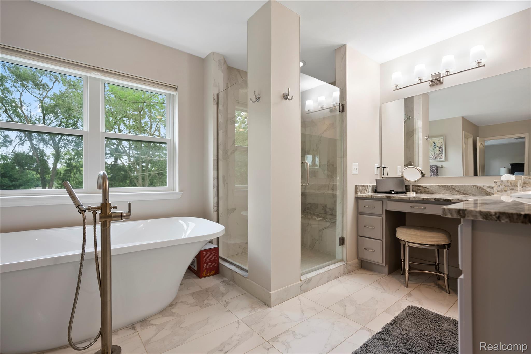 524 Ludlow Avenue Rochester, MI 48307 - Photo 16 of 36 Full bathroom featuring vanity, a freestanding tub, a stall shower, and light marble finish floors