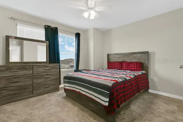 a bedroom with a bed and a dresser