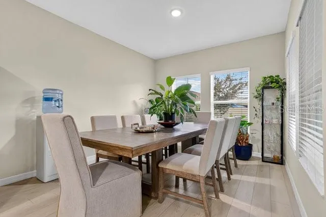 a view of a workspace with furniture and a potted plant