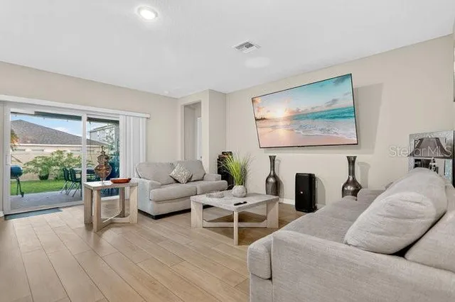 a living room with furniture a fireplace and a large window
