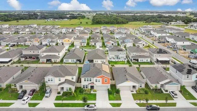 an aerial view of residential houses with outdoor space